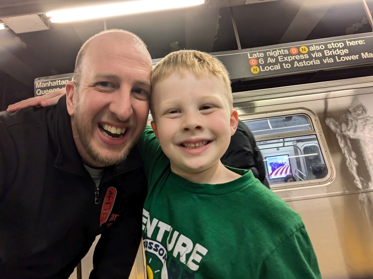 Alec Miller with his son on the subway